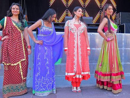 Four models standing together on the runway